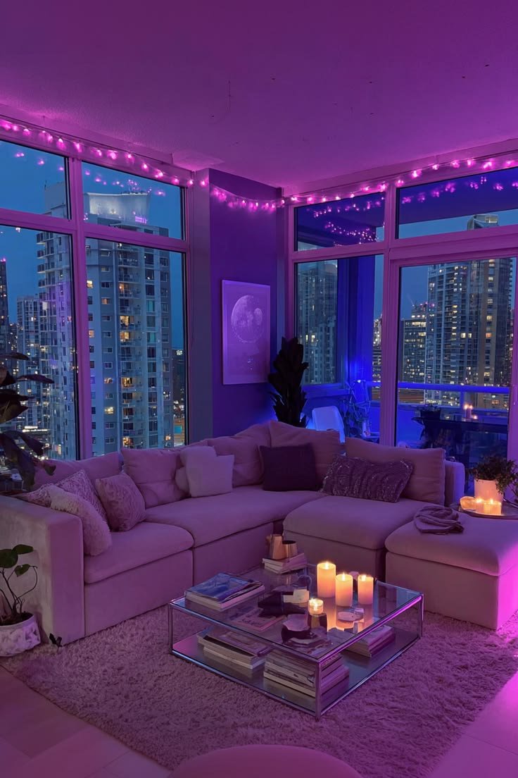 Sophisticated living room with deep purple accent lighting, low modern sectional, and candles on glass coffee table overlooking nighttime city skyline